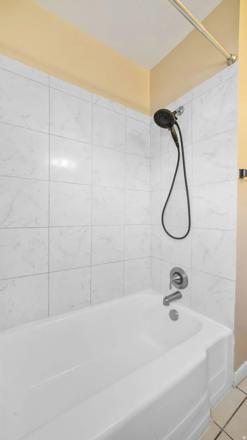 Full bathroom featuring bathing tub / shower combination and tile patterned flooring