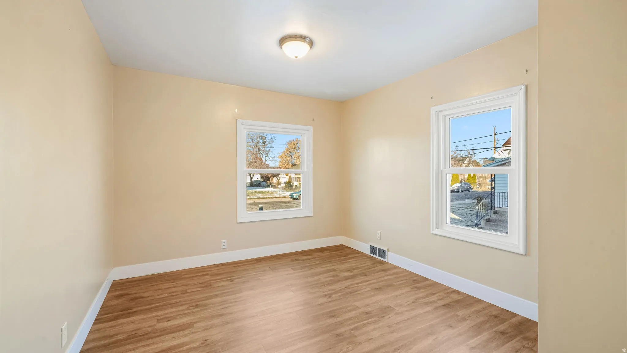 Spare room featuring plenty of natural light and light wood finished floors