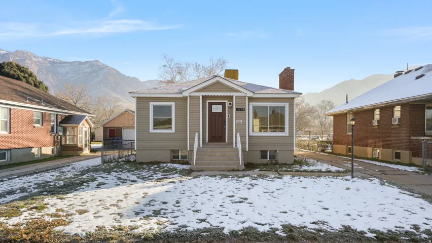 Bungalow-style home featuring a chimney and a mountain view