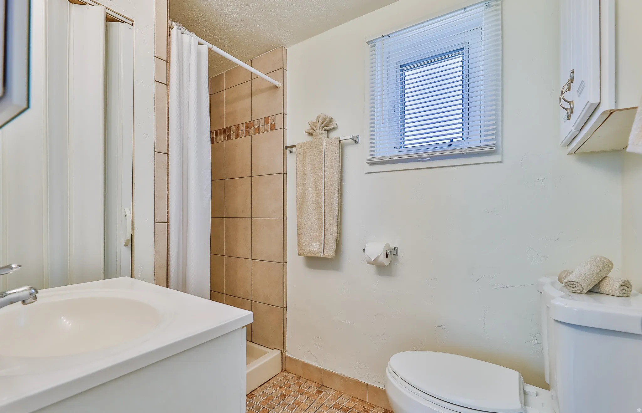Bathroom with a shower stall and vanity