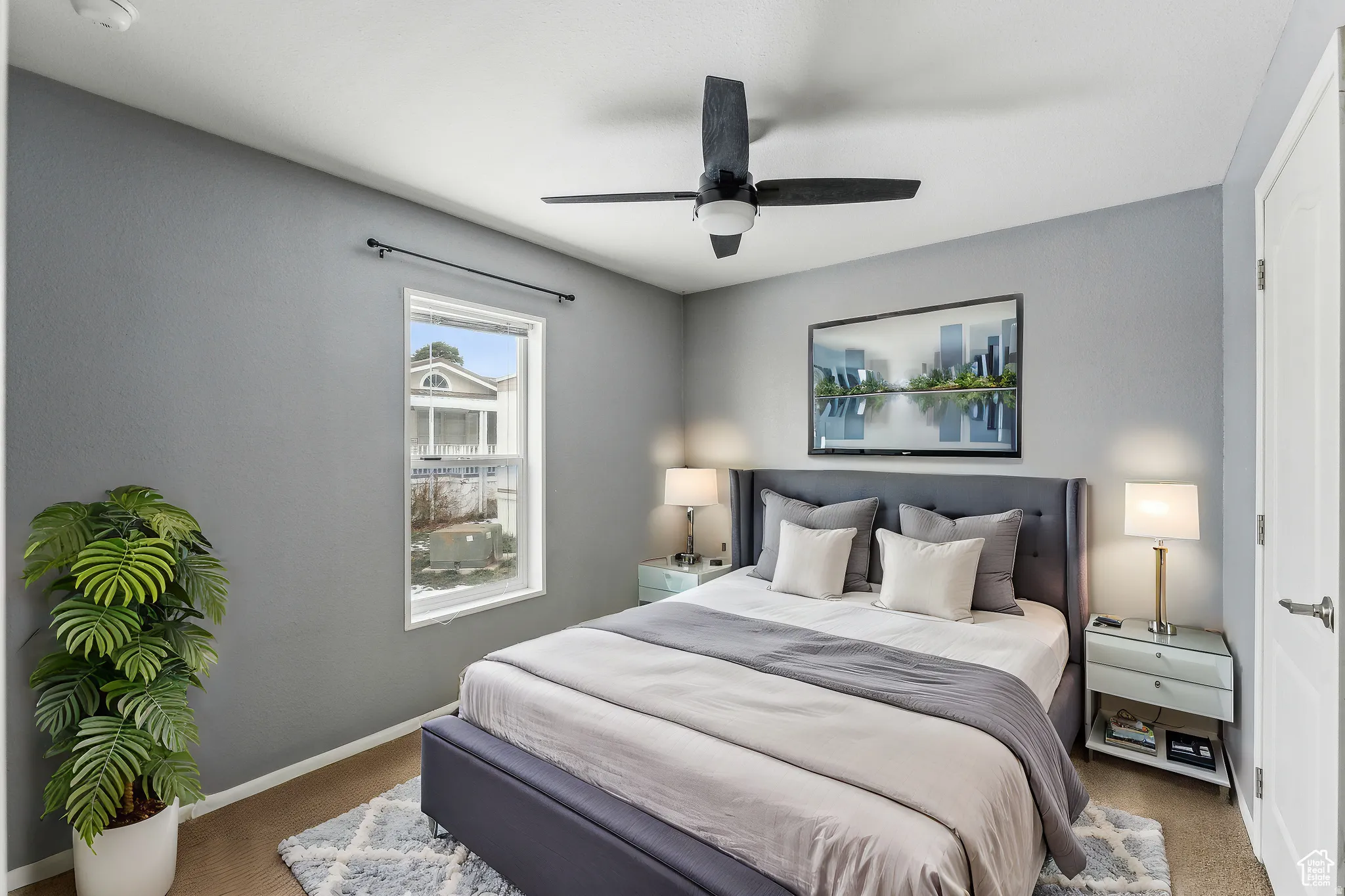 Bedroom with ceiling fan and carpet