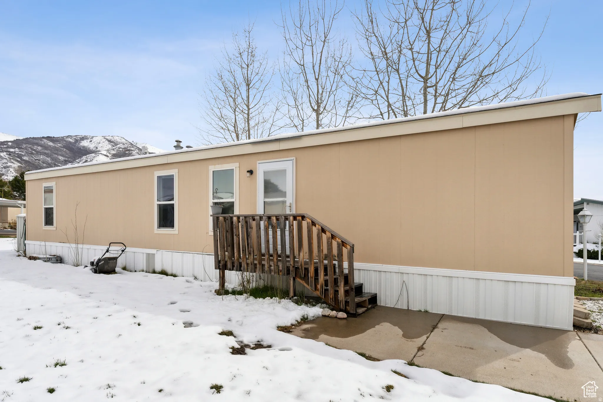View of snow covered rear of property