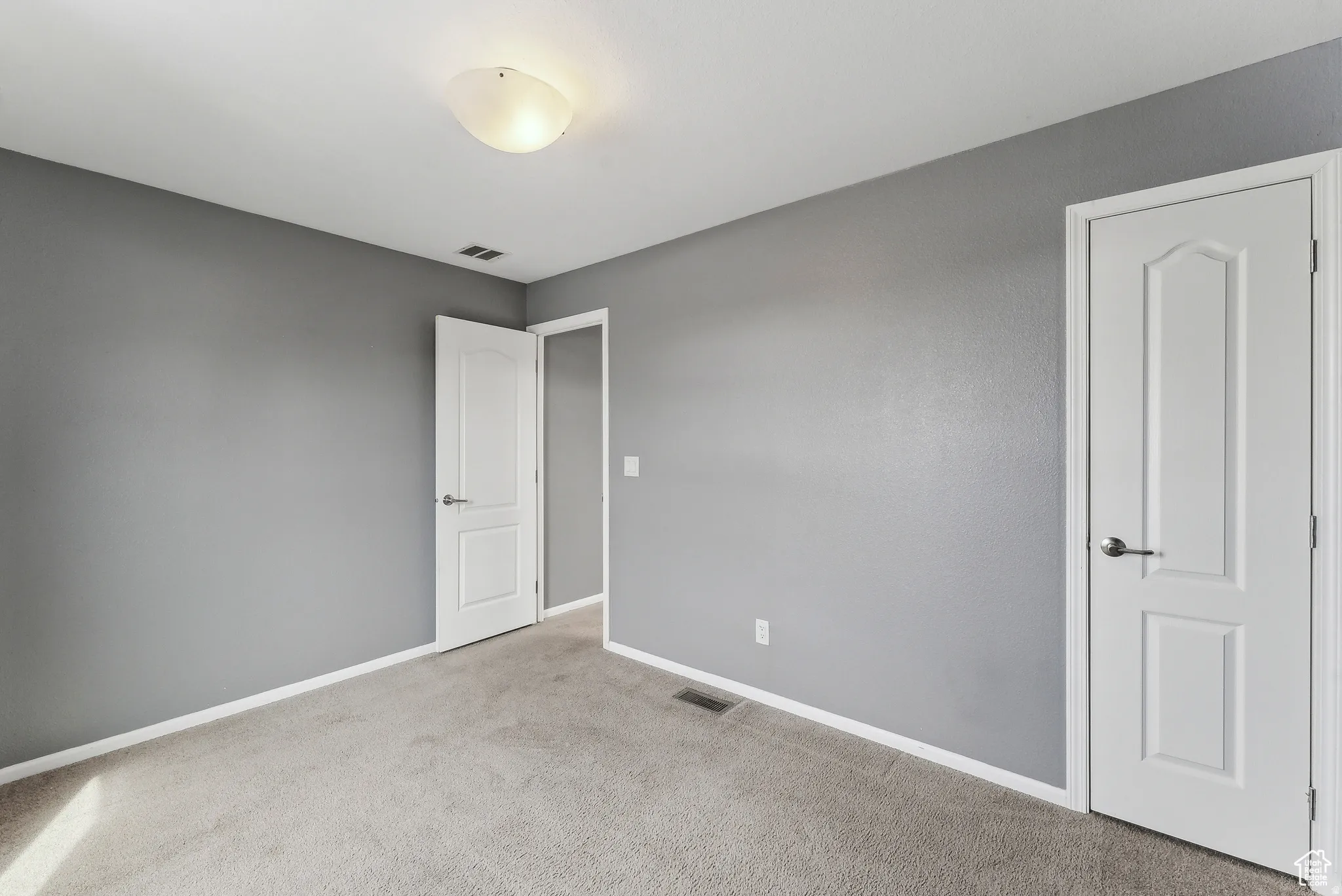 Unfurnished bedroom with carpet and baseboards