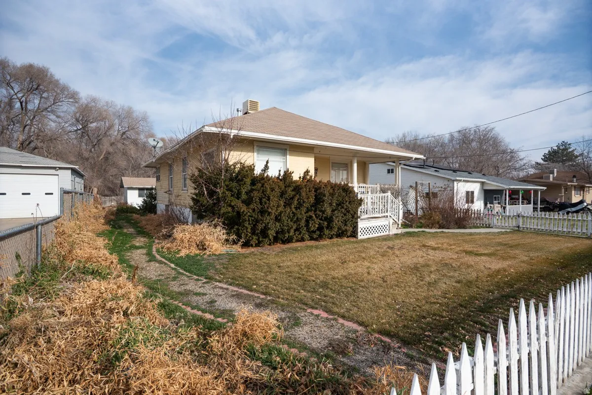 View of front of home with covered porch and a chimney