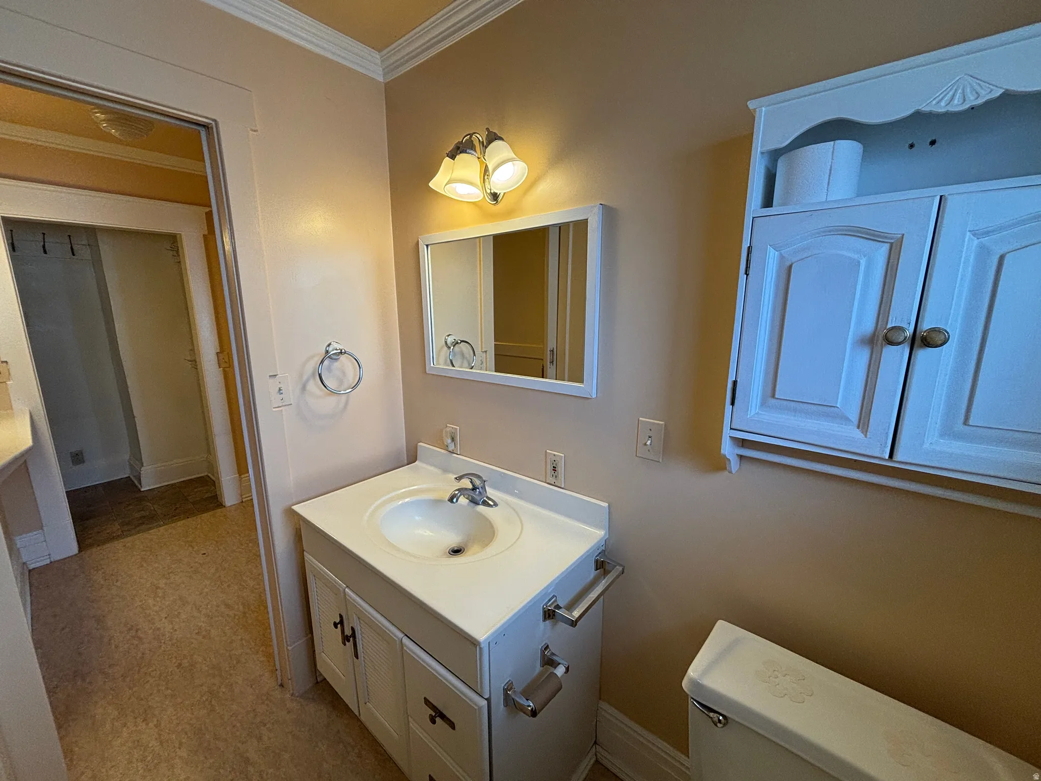 Half bath with vanity and crown molding