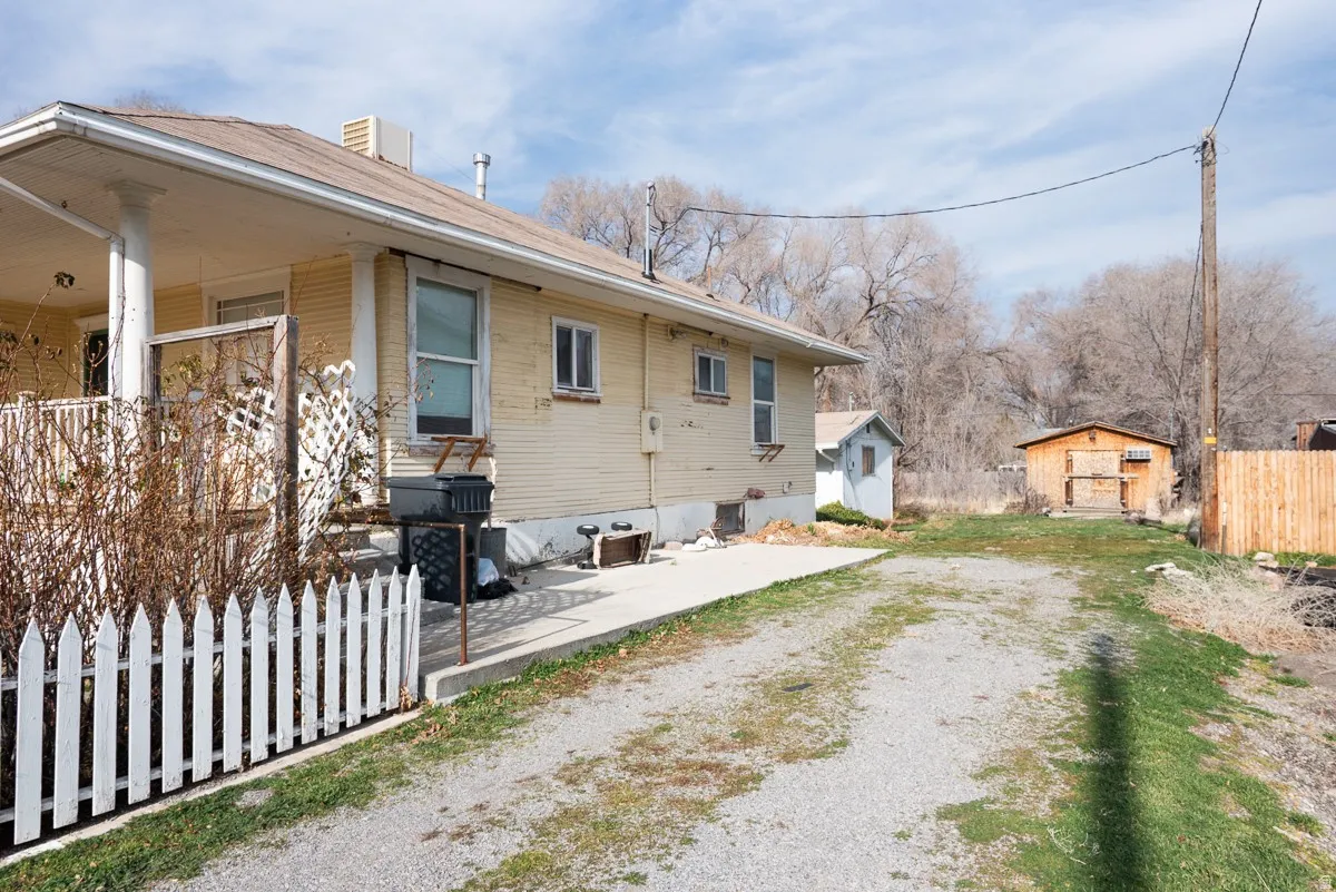 View of side of home featuring a patio area and a chimney