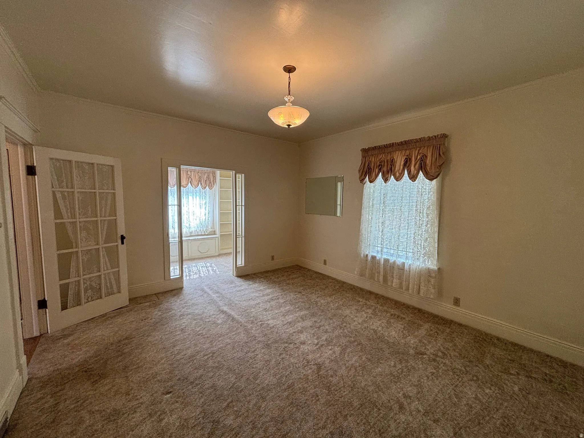 Empty room with carpet floors and ornamental molding