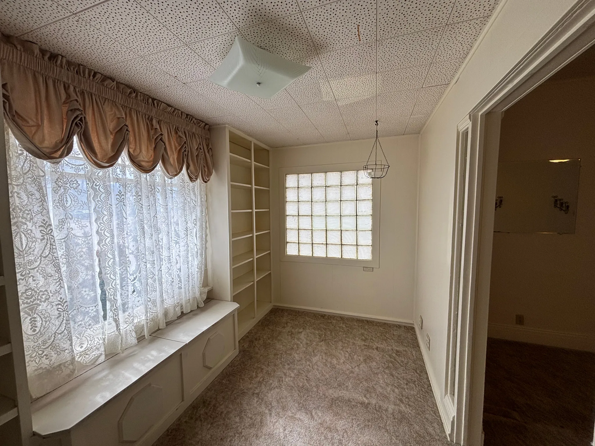 Mudroom featuring light colored carpet and baseboards