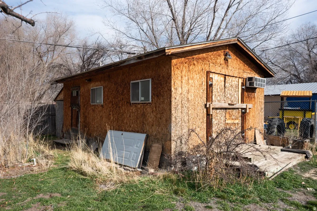 View of side of home featuring an outdoor structure