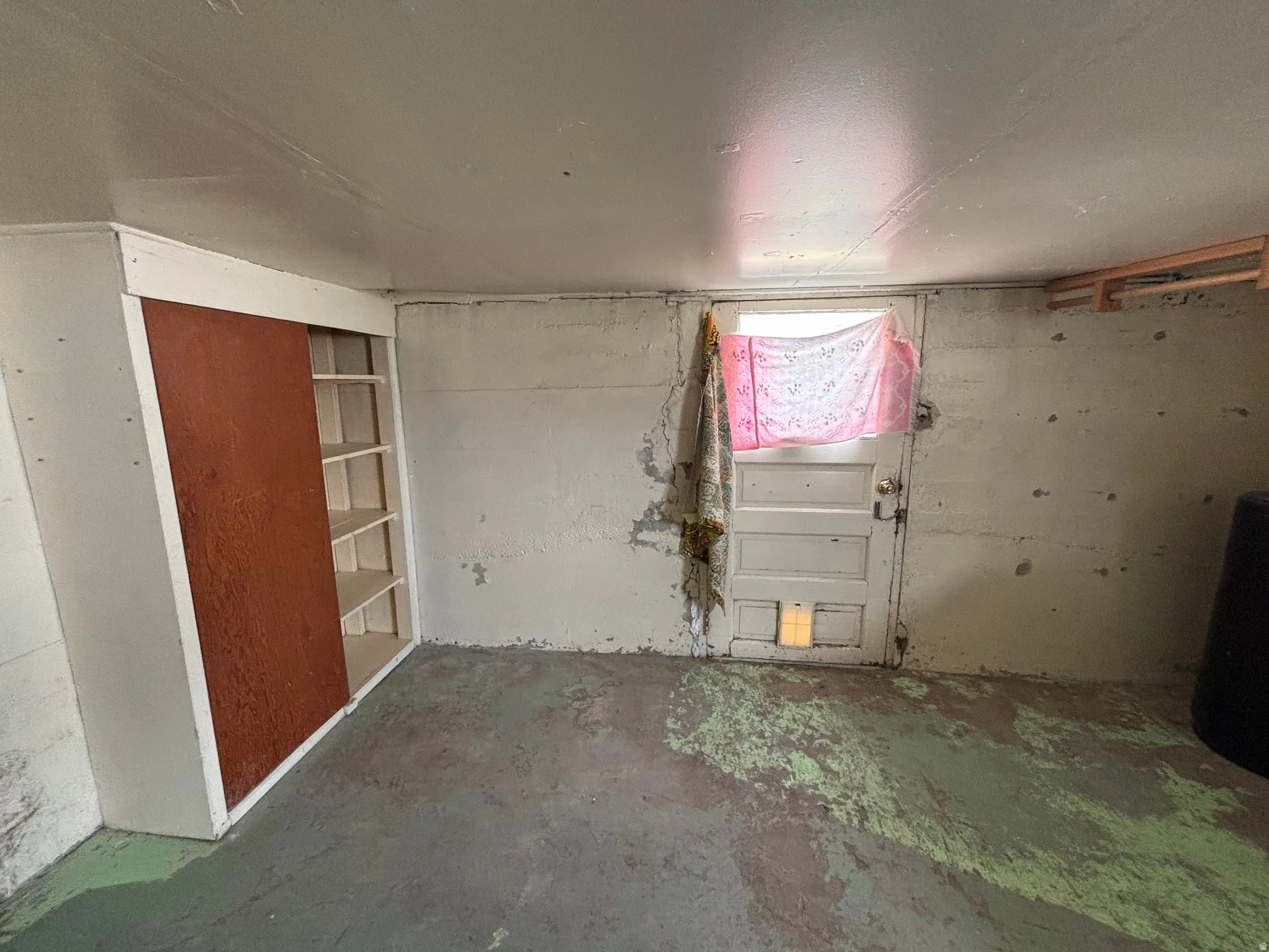 Spare room featuring unfinished concrete flooring