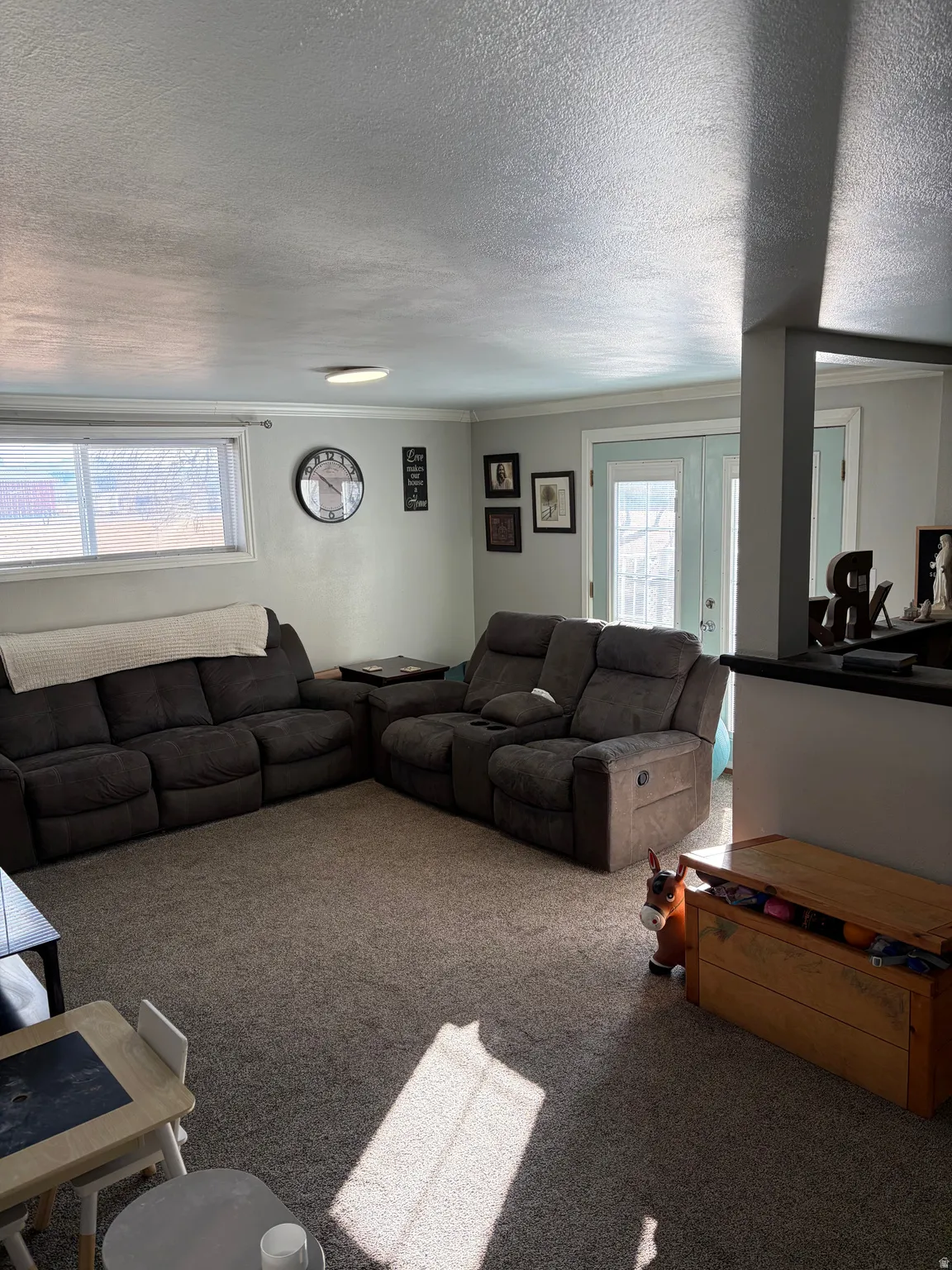 Carpeted living area with a textured ceiling