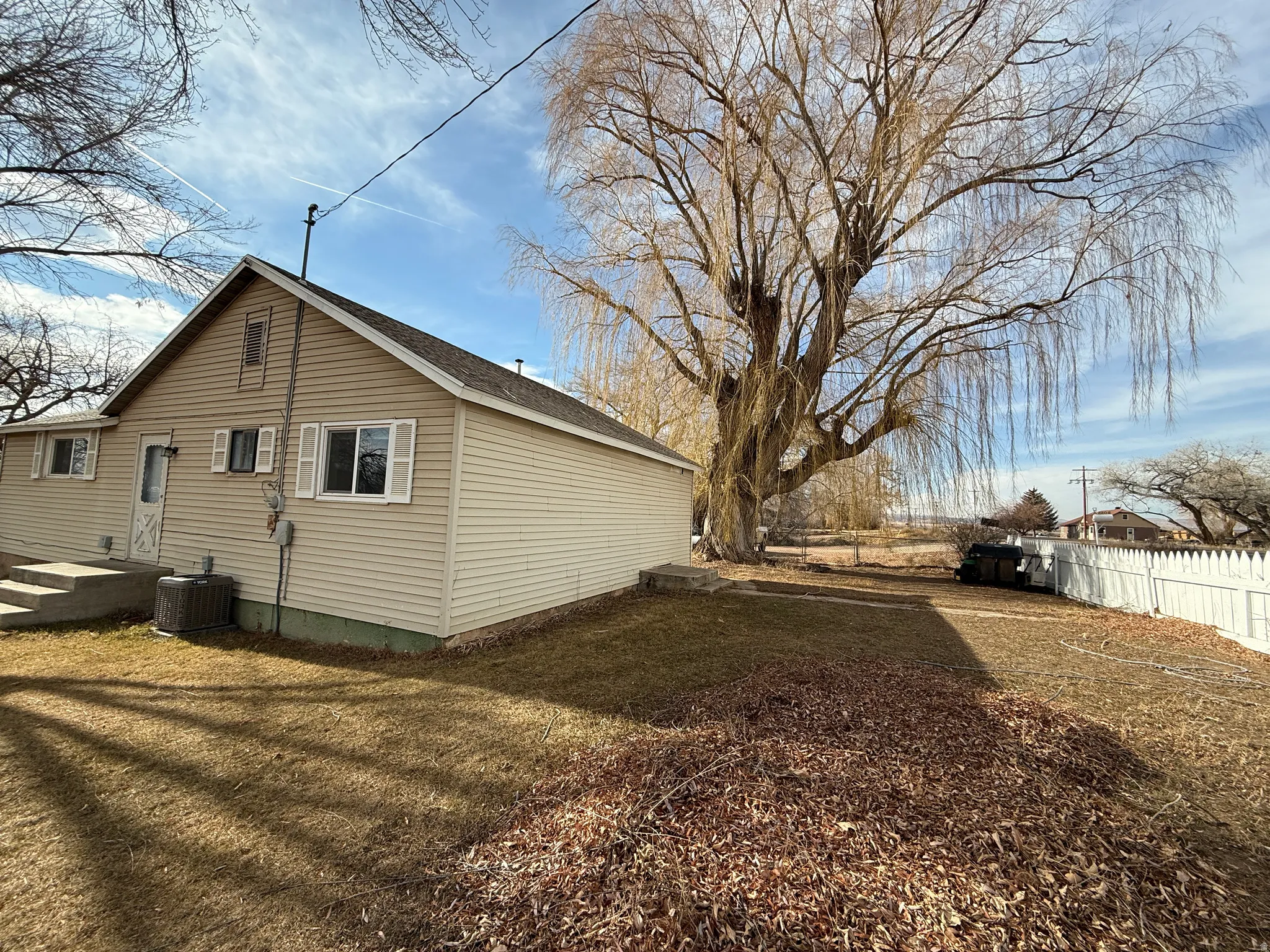 View of side of property featuring a central AC unit