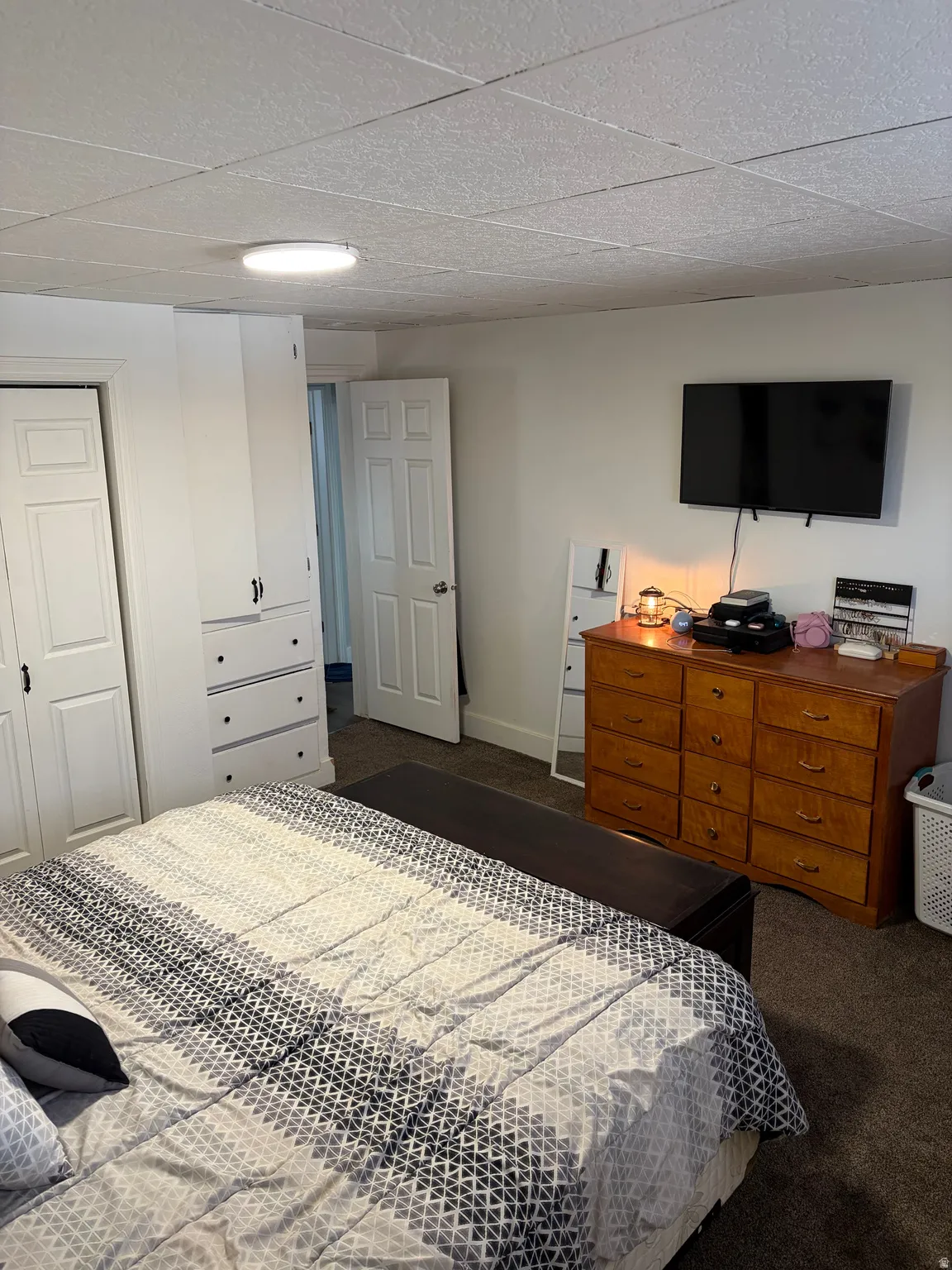 Carpeted bedroom featuring a closet and baseboards