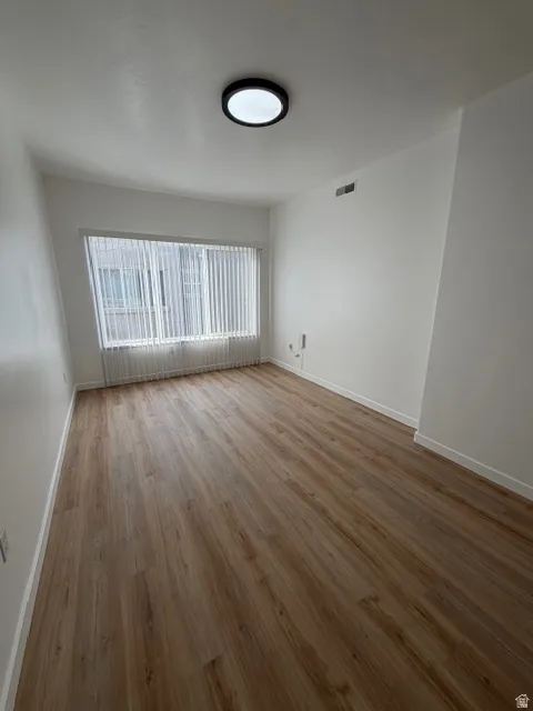 Spare room with light wood-style flooring and baseboards