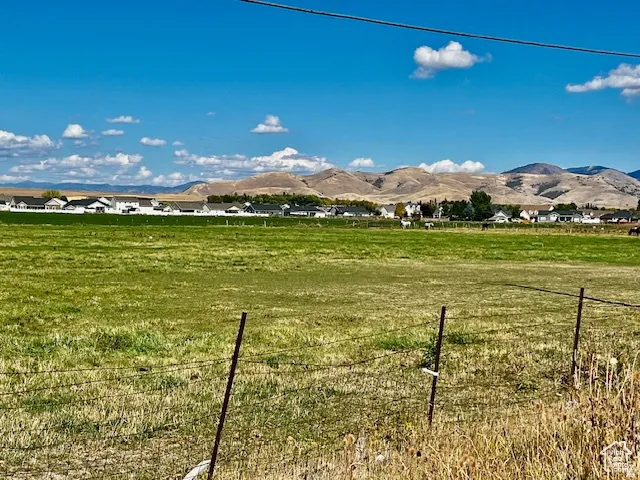View of mountain backdrop with rural landscape