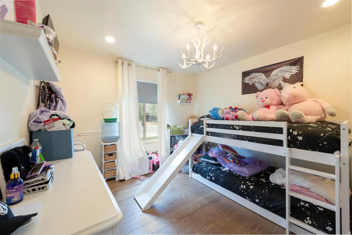 Bedroom with recessed lighting, light wood-type flooring, and a chandelier
