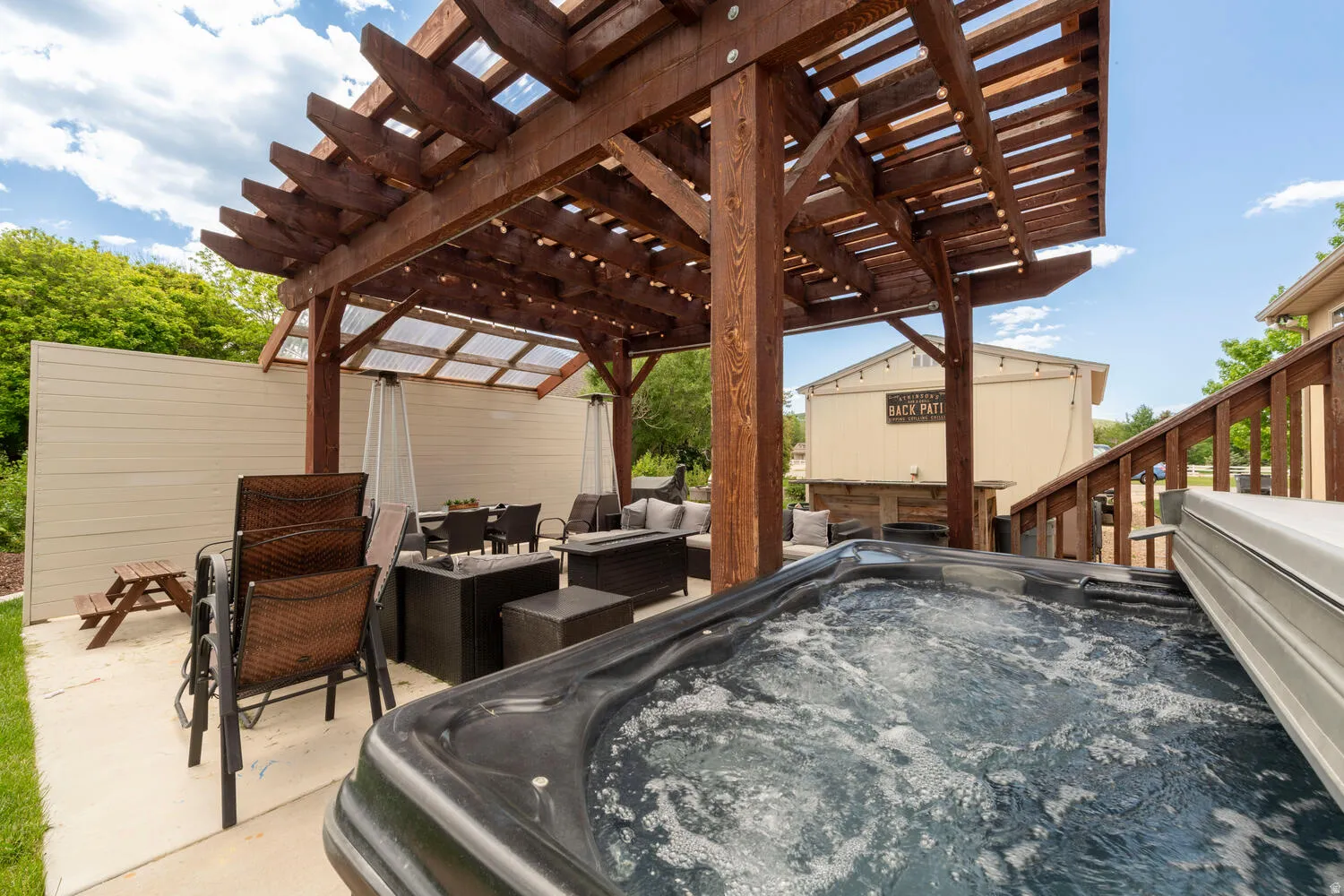 View of patio with a hot tub, outdoor lounge area, and a pergola
