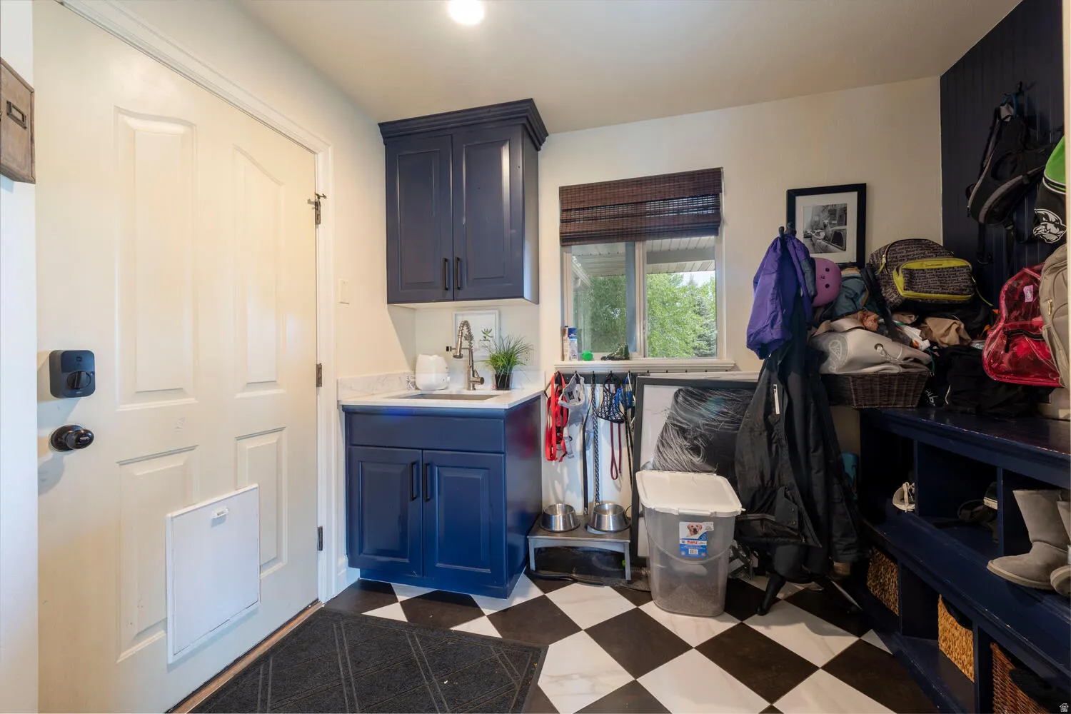 Laundry room with dark flooring and a sink
