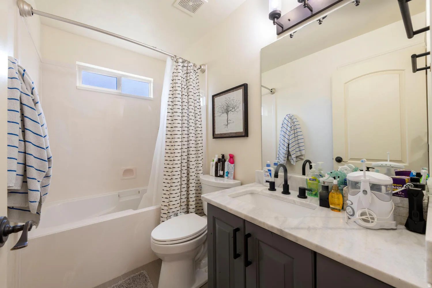 Bathroom featuring shower / bath combo and vanity