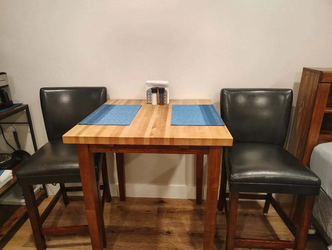Dining area with dark wood-type flooring