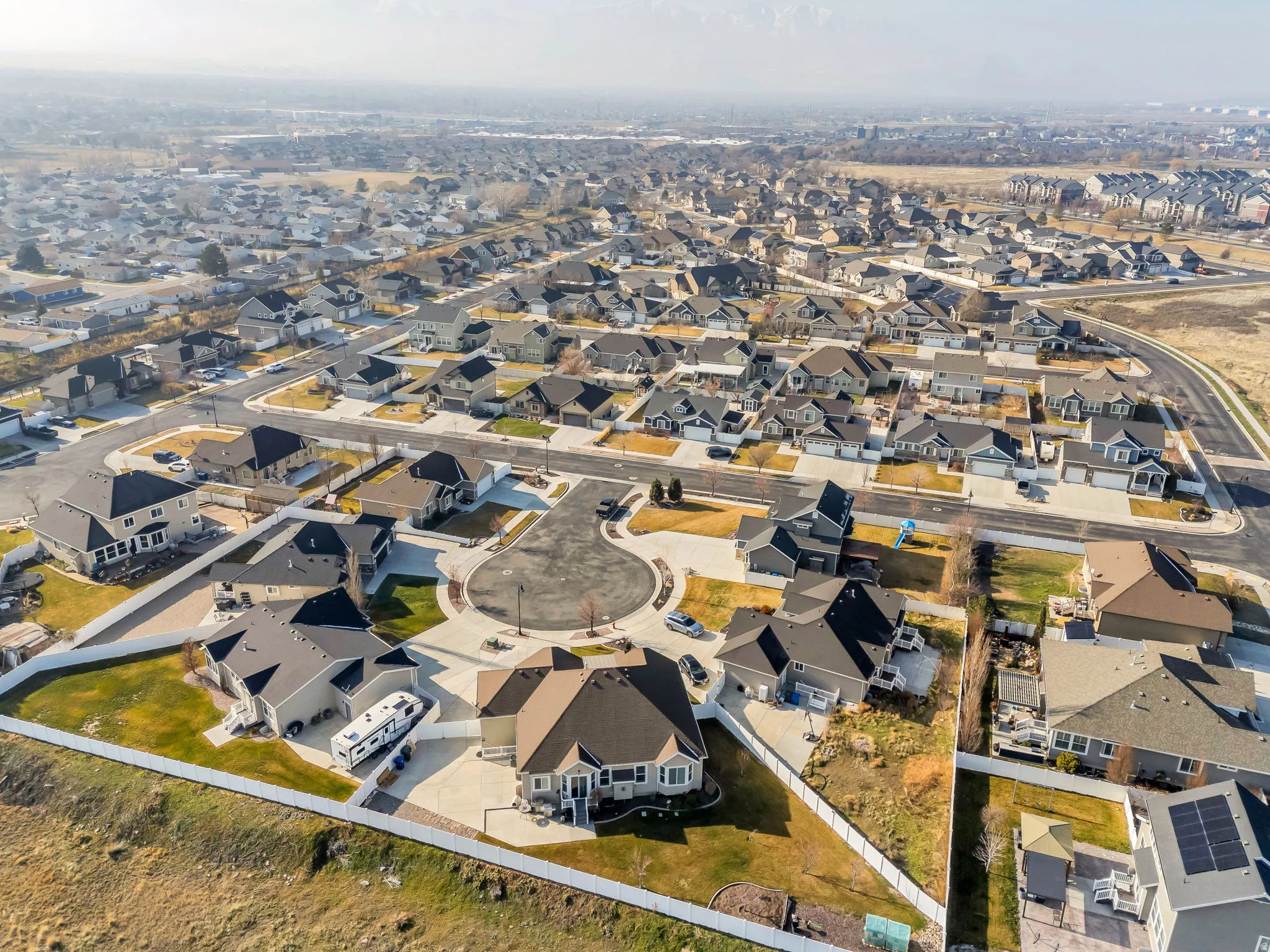Aerial view of property and surrounding area with nearby suburban area