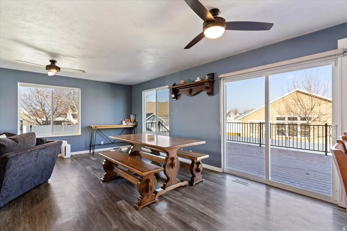 Dining room with a ceiling fan and dark wood-style flooring