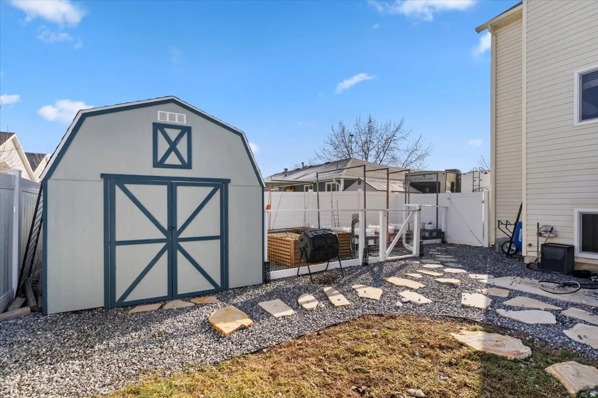 View of shed featuring a fenced backyard