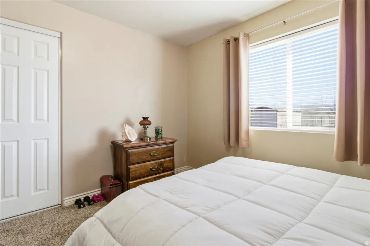 Carpeted bedroom featuring baseboards