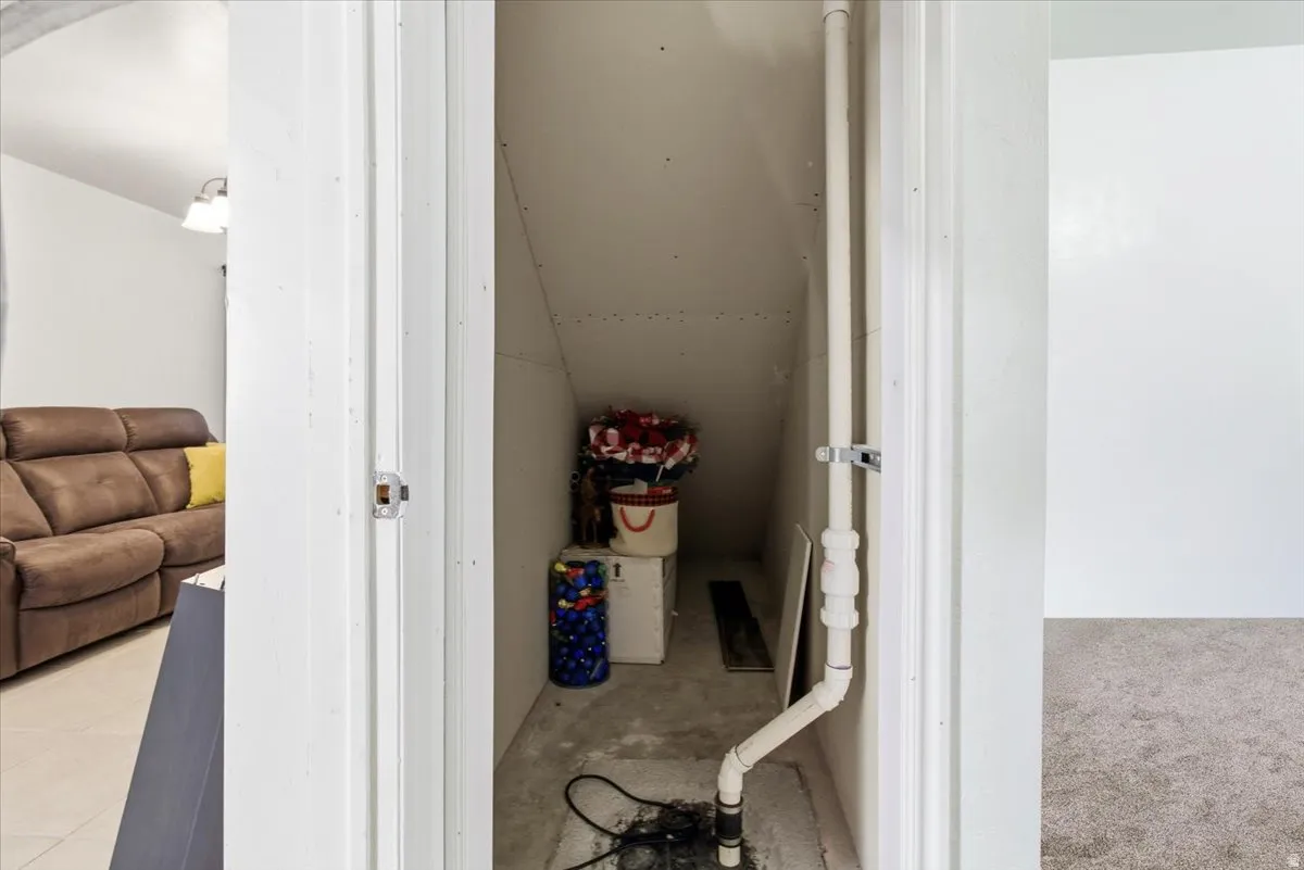 Bathroom featuring vaulted ceiling and tile patterned flooring