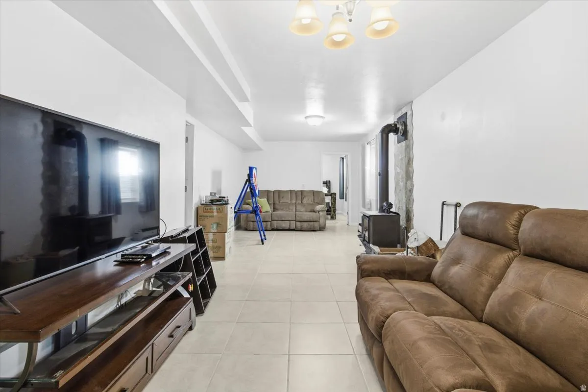 Living area with a wood stove and light tile patterned floors