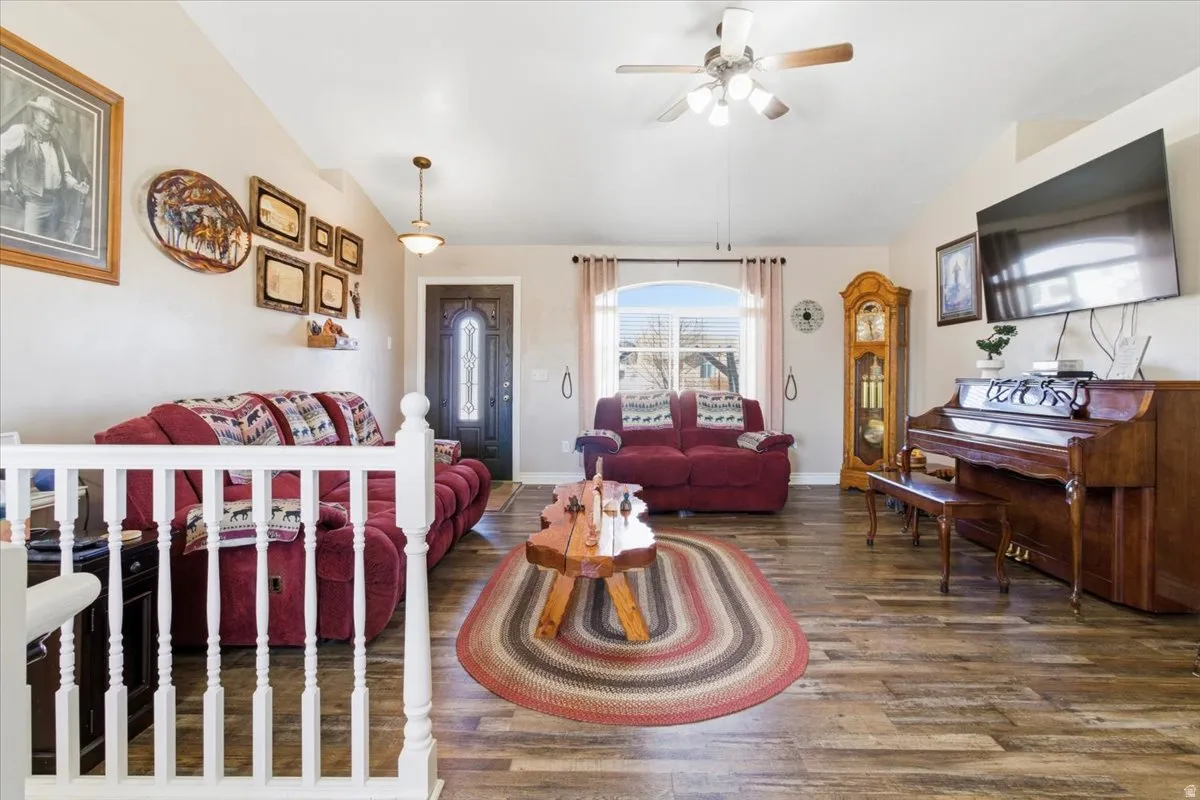 Living area featuring wood finished floors and ceiling fan