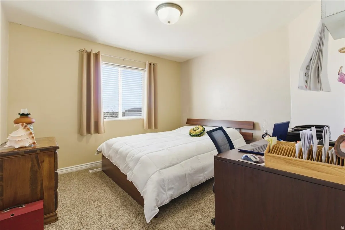 Bedroom featuring carpet floors and baseboards