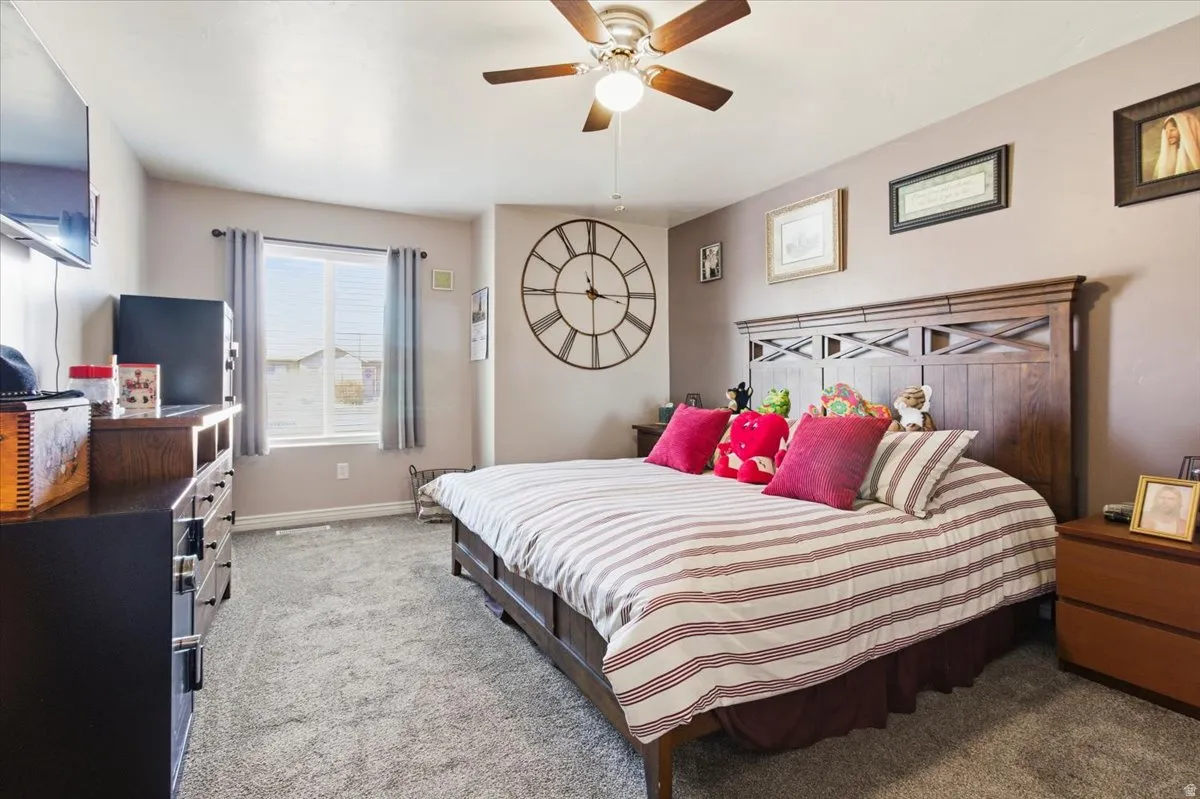 Bedroom with carpet and a ceiling fan
