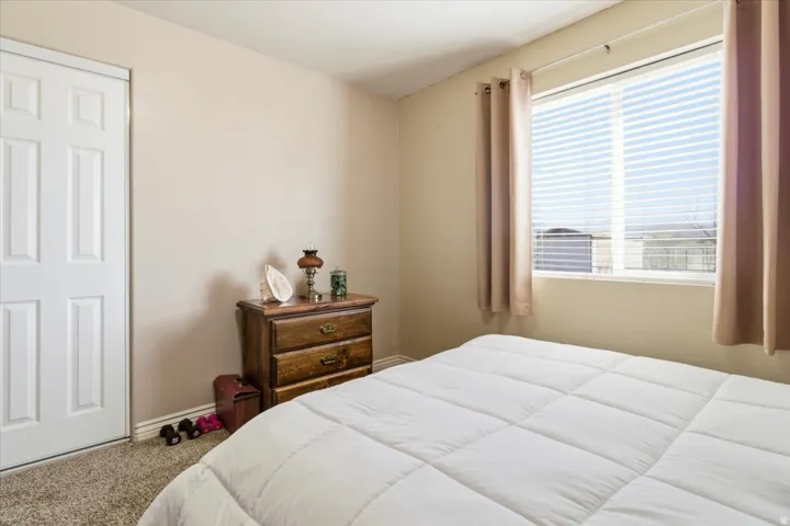 Carpeted bedroom featuring baseboards