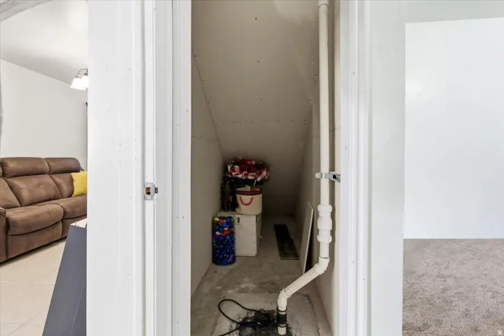Bathroom featuring vaulted ceiling and tile patterned flooring