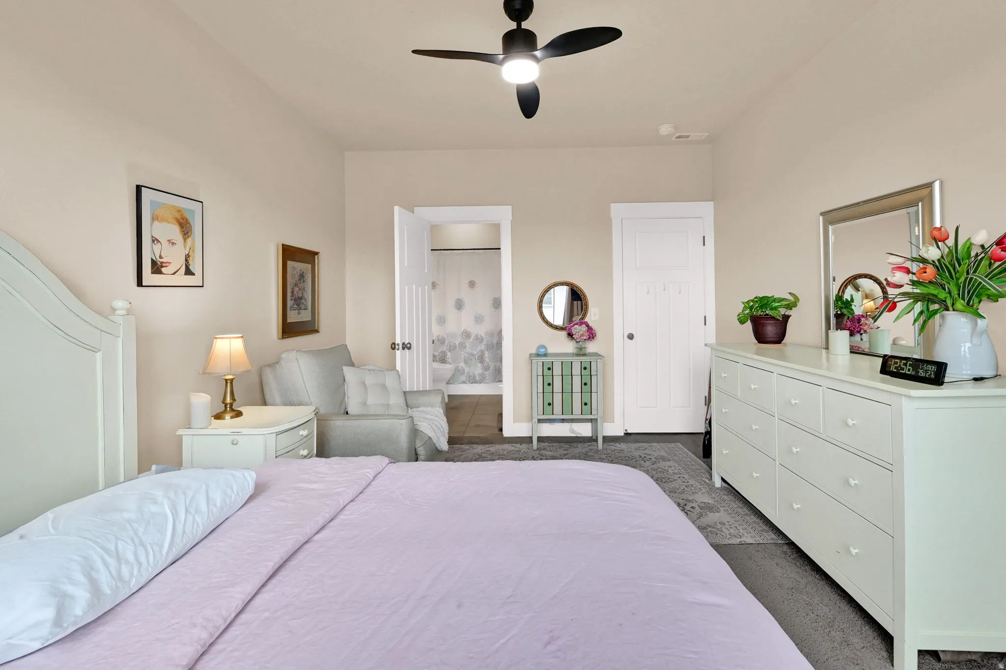 Bedroom featuring a ceiling fan and connected bathroom