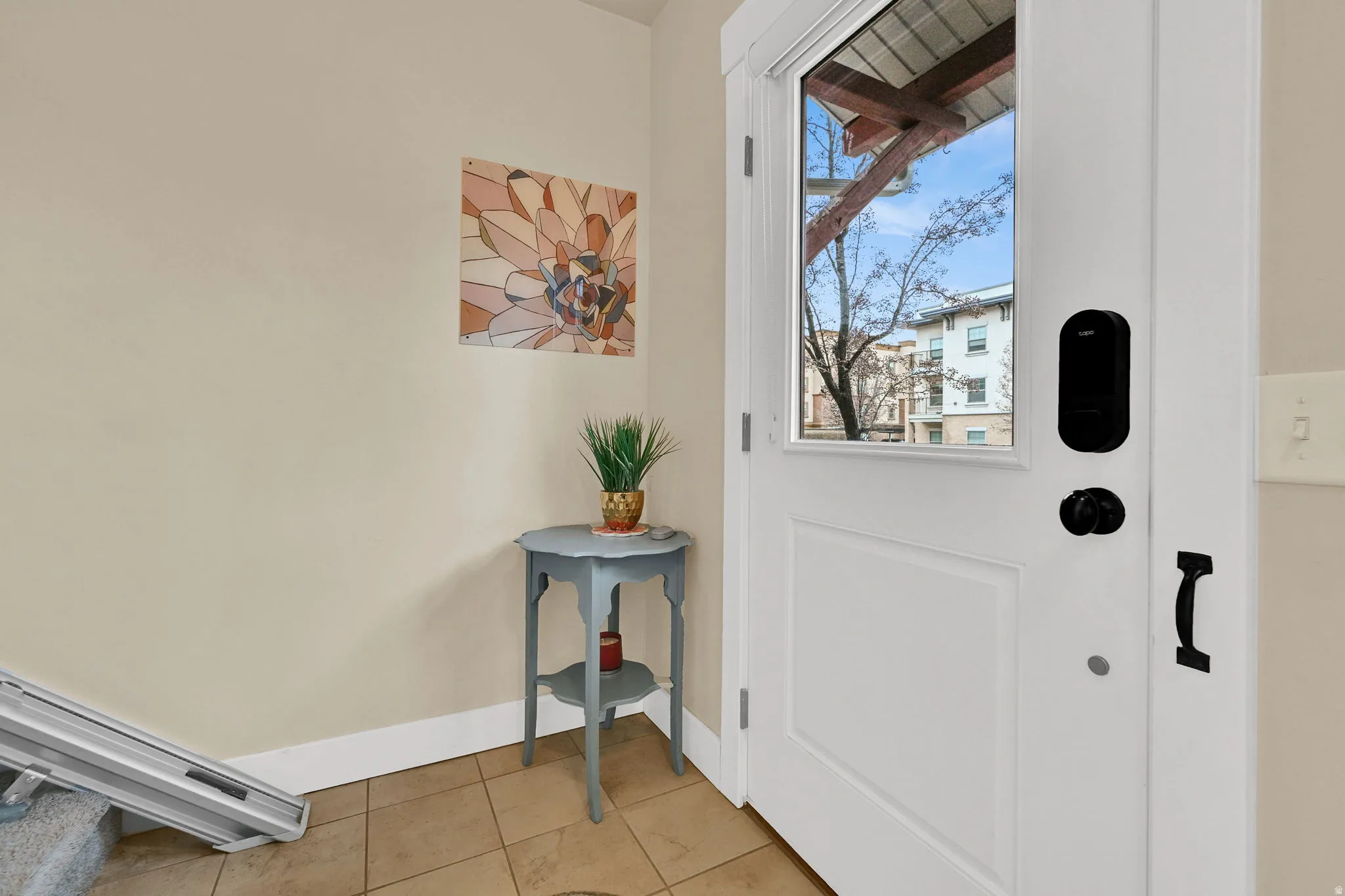 Entryway featuring light tile patterned floors and baseboards