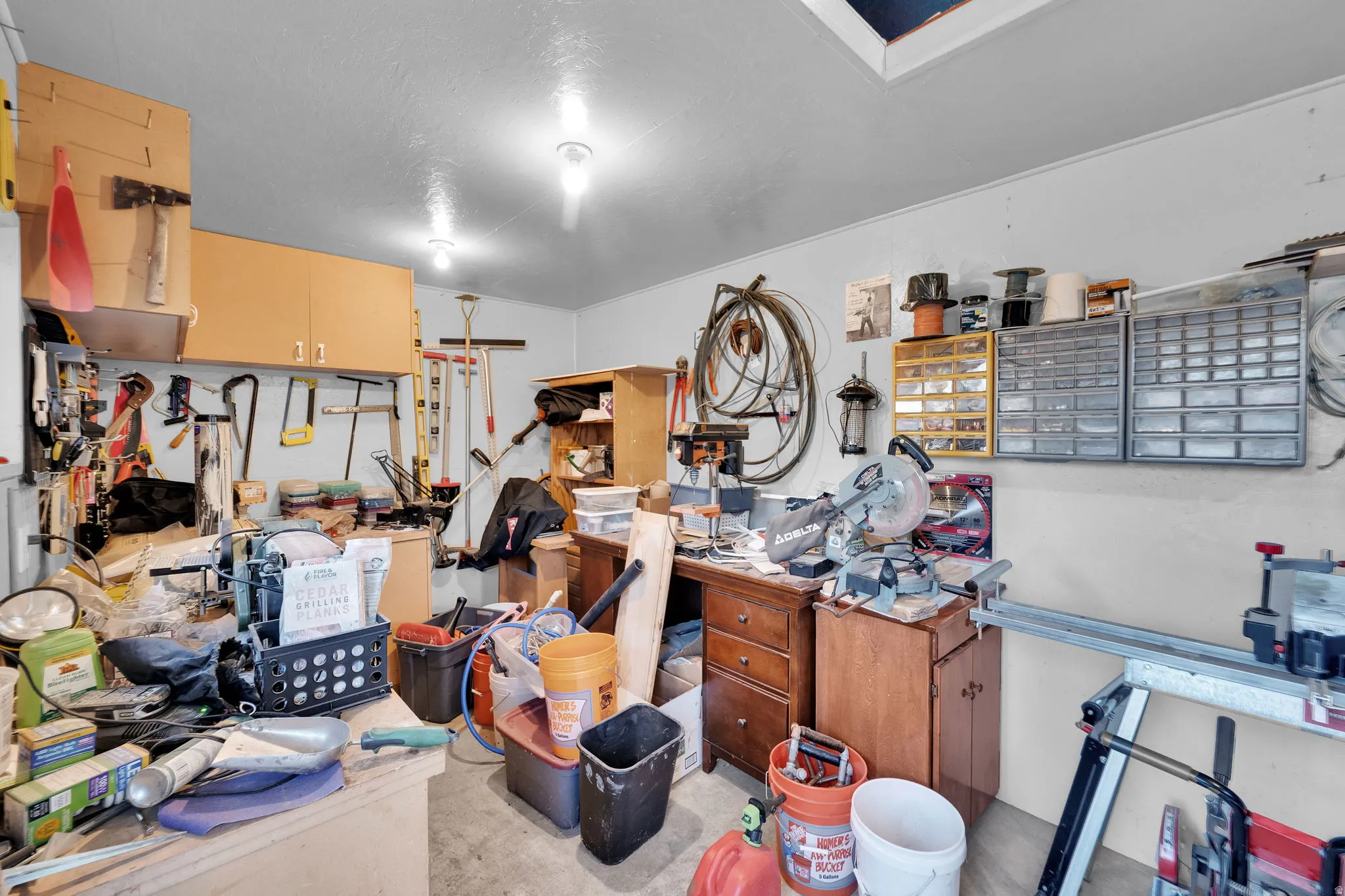 Miscellaneous room featuring a workshop area and unfinished concrete flooring