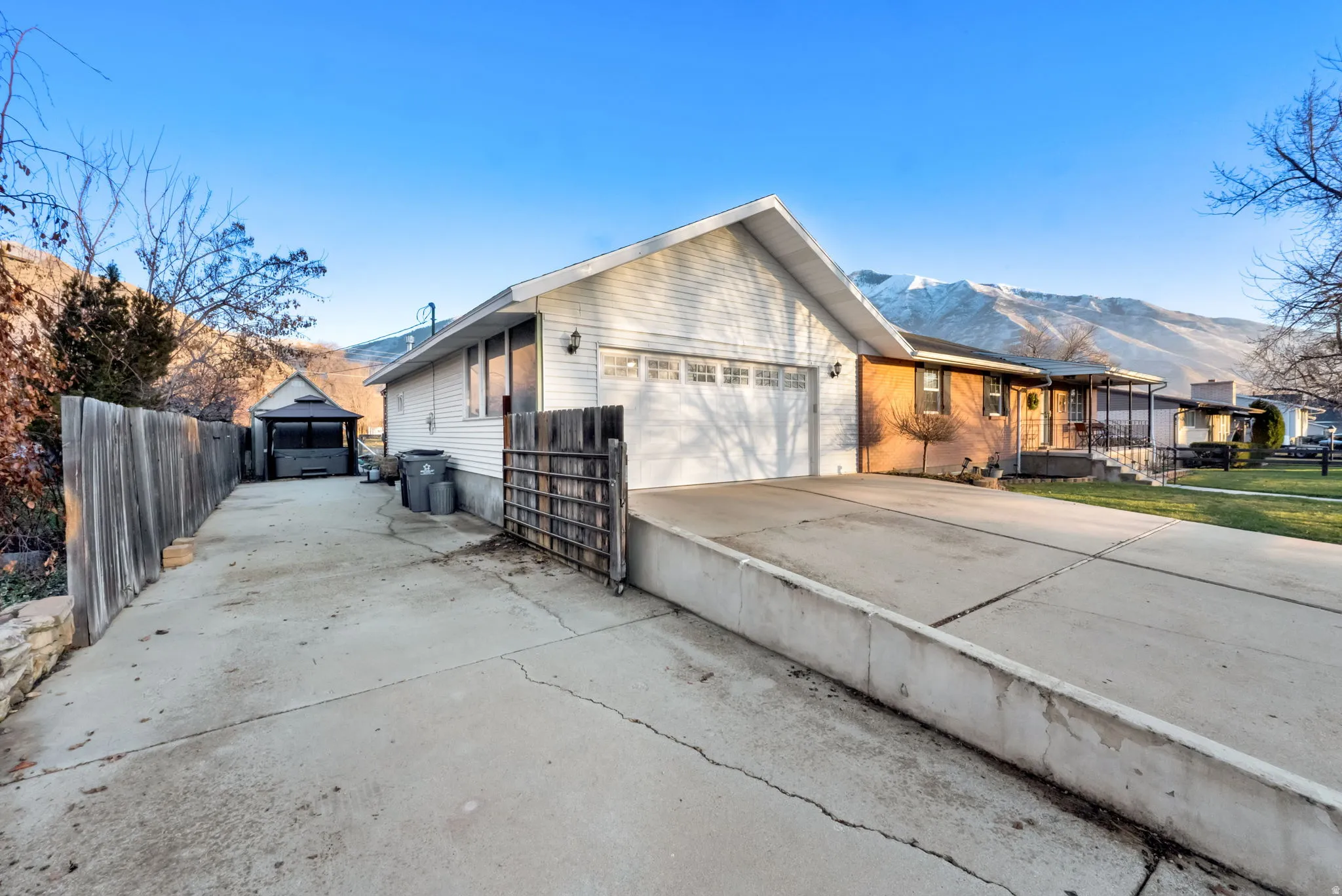 View of front facade with concrete driveway and a mountain view