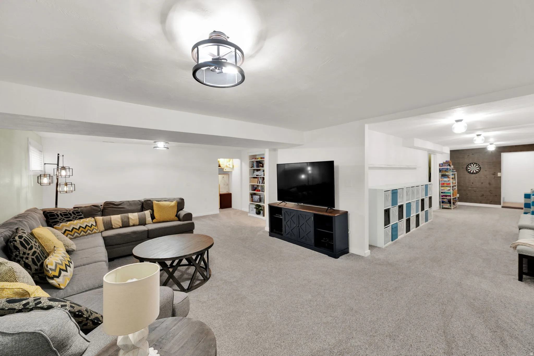 Carpeted living area featuring built in shelves