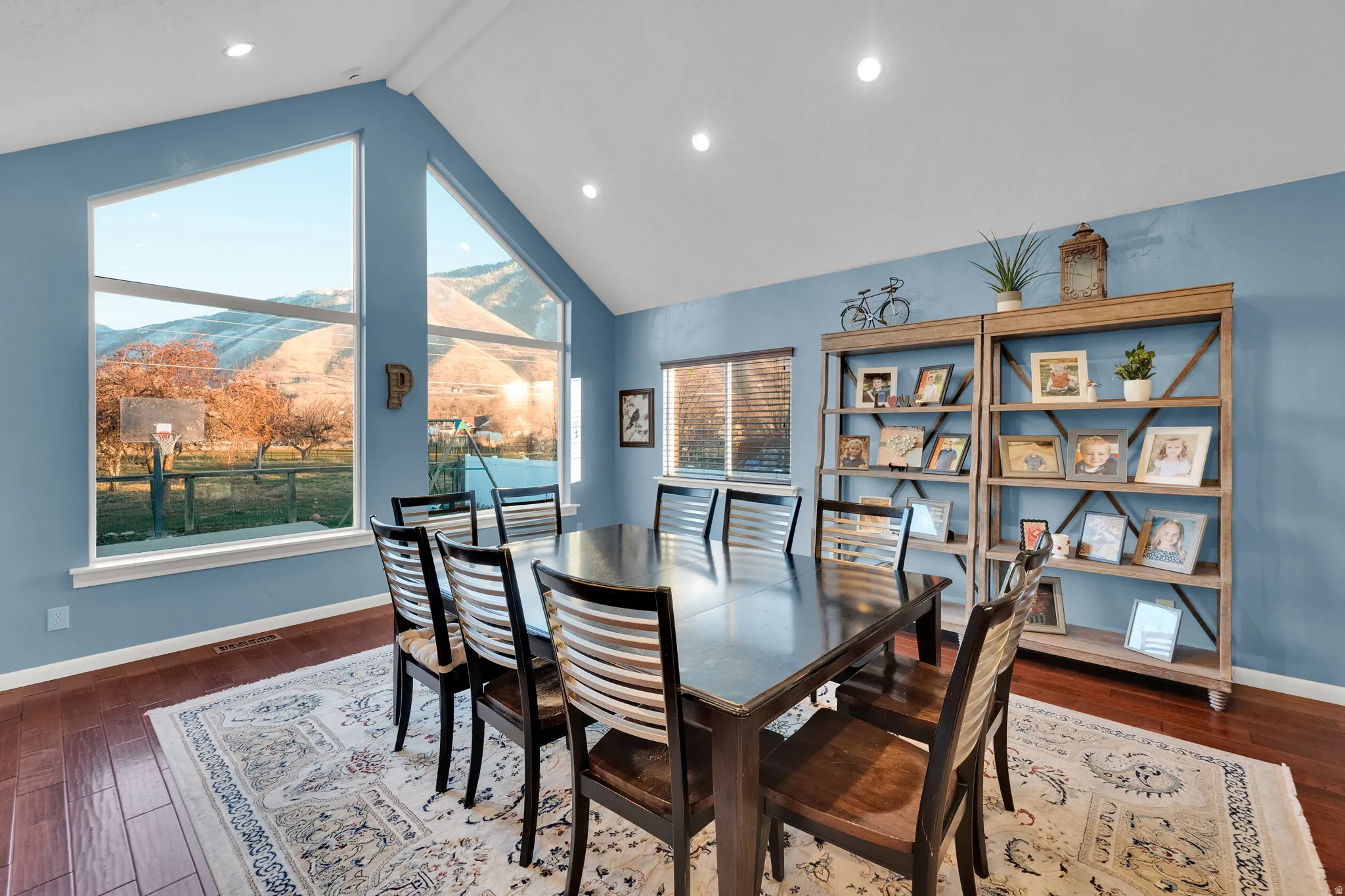 Dining space featuring a mountain view, dark wood finished floors, and recessed lighting