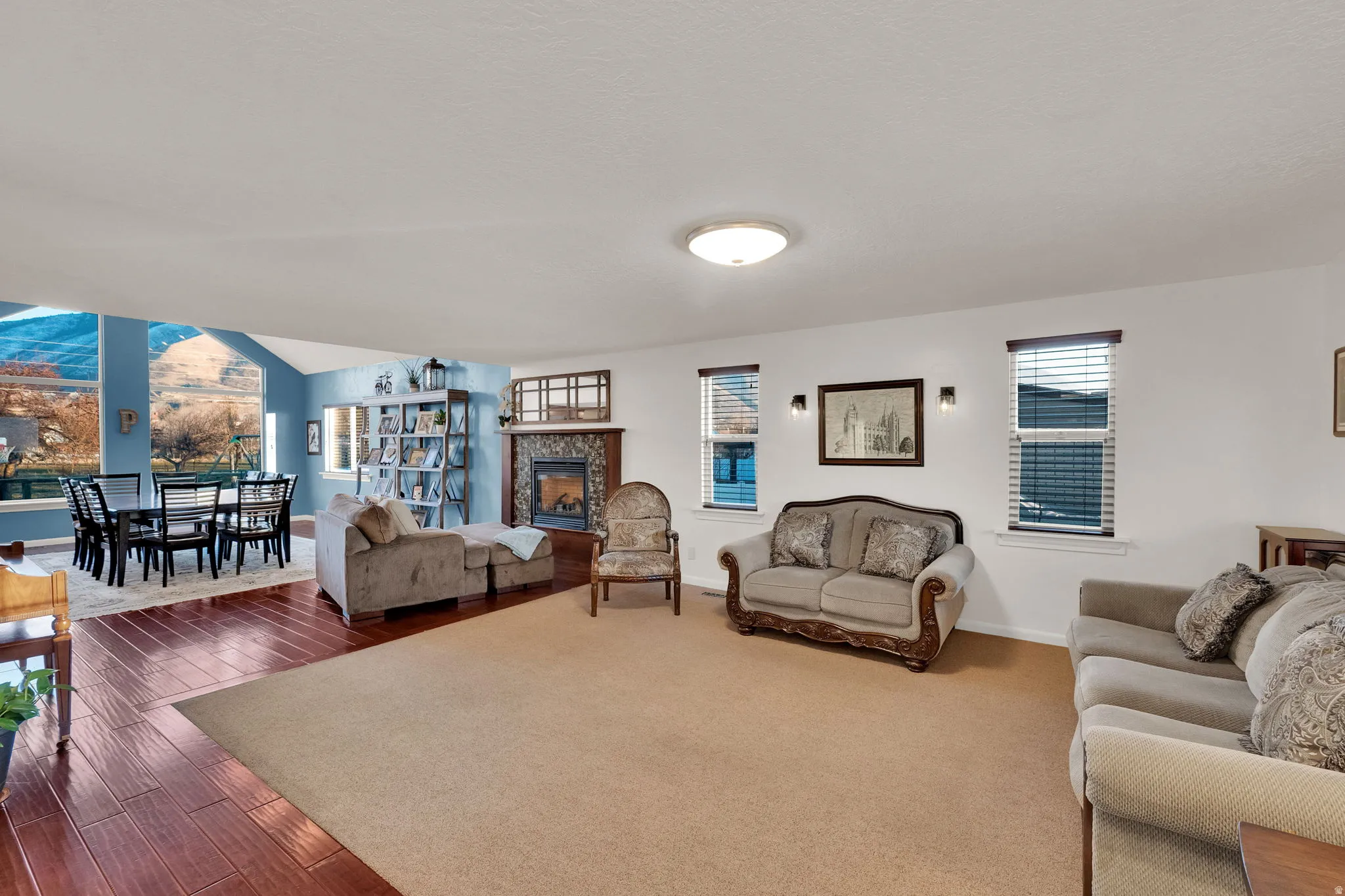 Living area featuring dark wood-style floors and a tiled fireplace