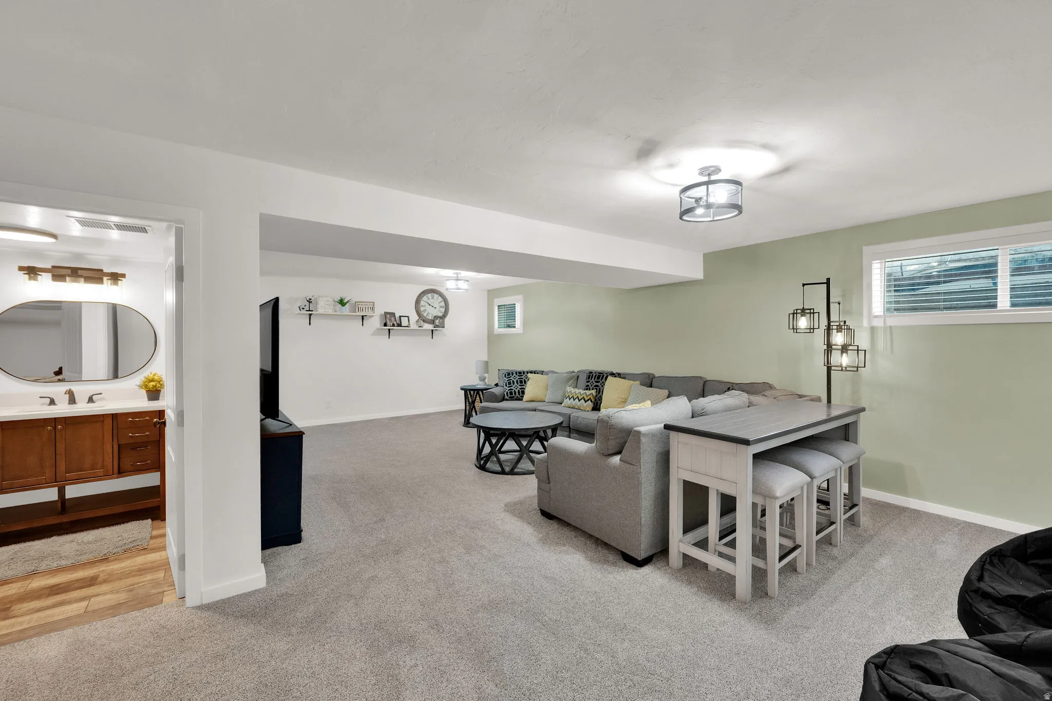 Living area with light carpet and baseboards