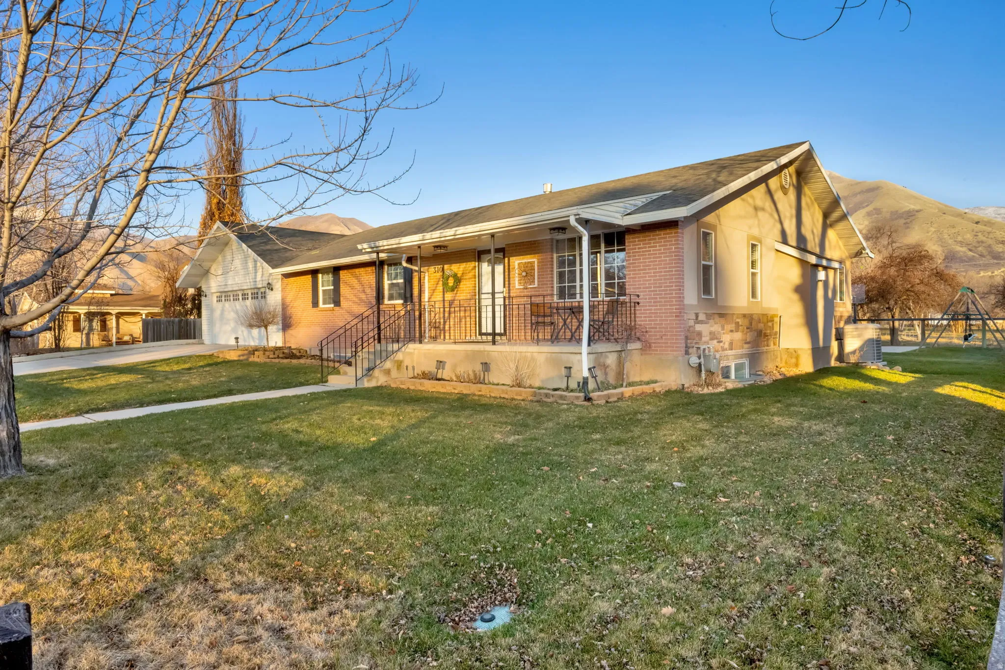 Ranch-style house featuring brick siding, a garage, concrete driveway, and a shingled roof