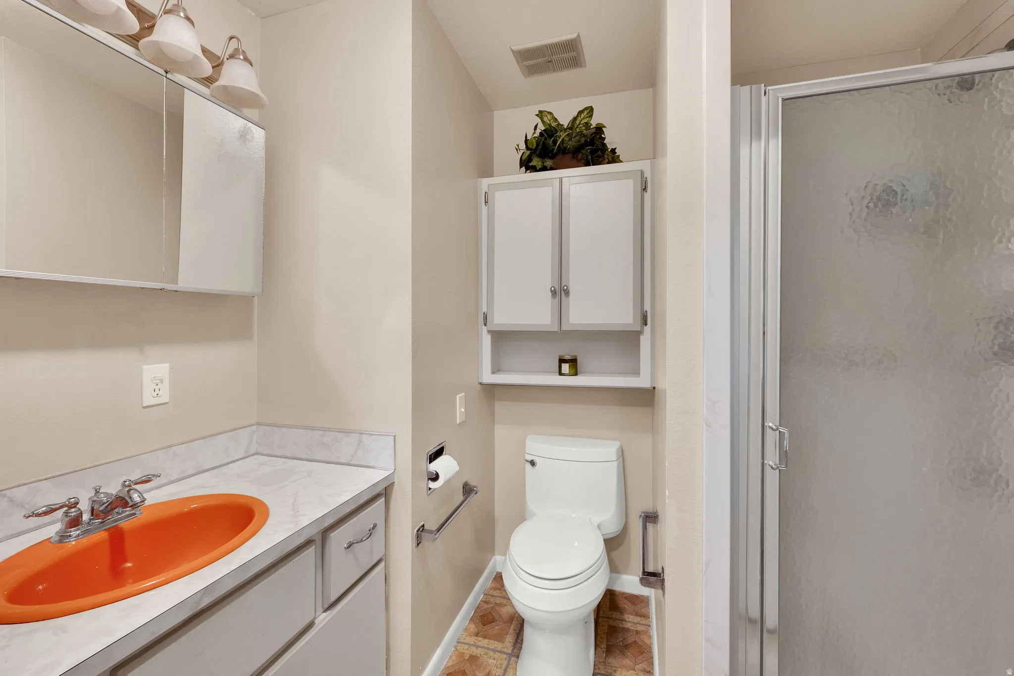 Full bathroom featuring vanity and a shower stall