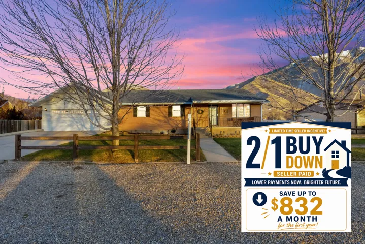 Single story home featuring a fenced front yard, driveway, and brick siding