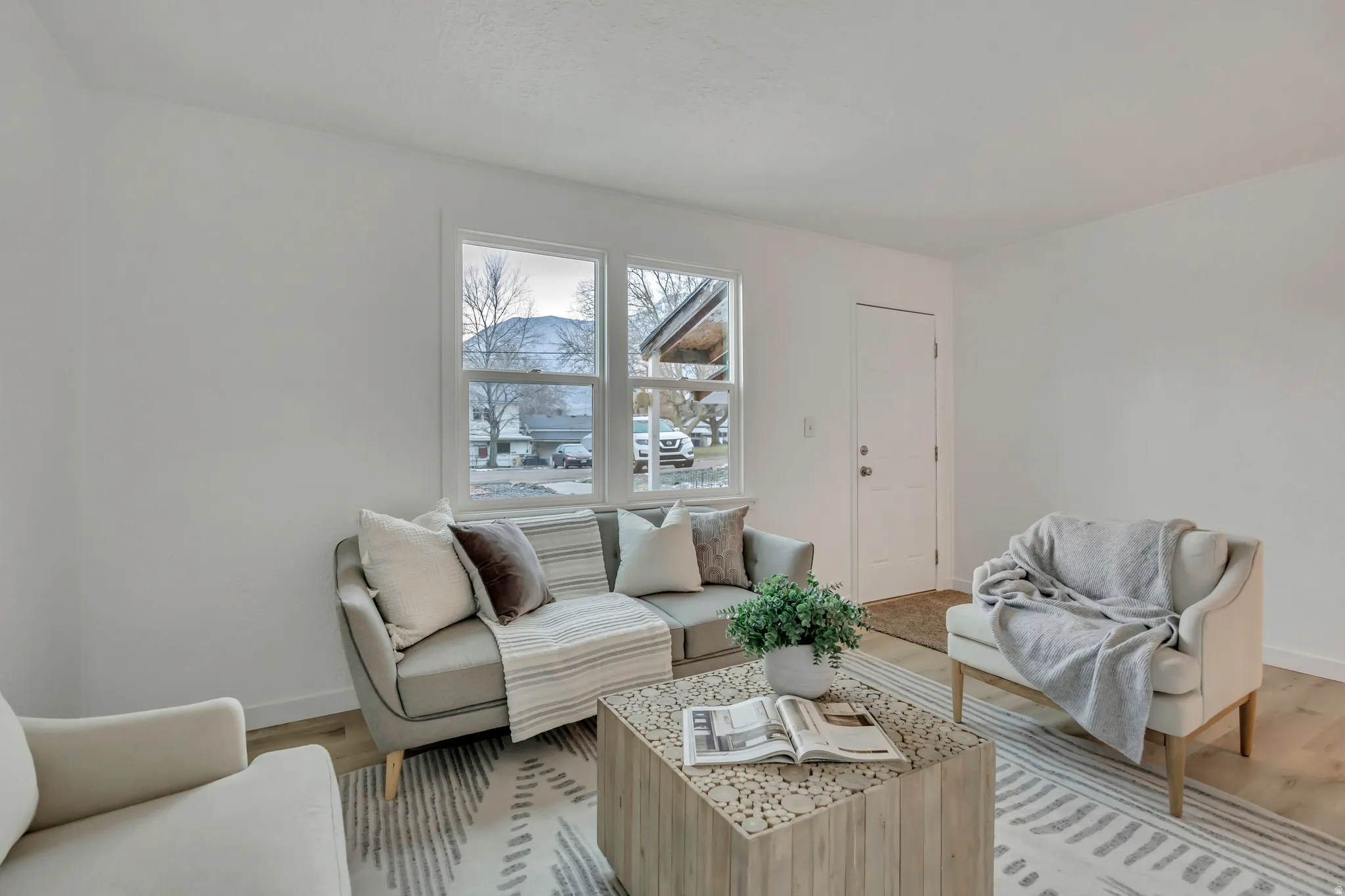 Living area featuring light wood-style flooring and baseboards