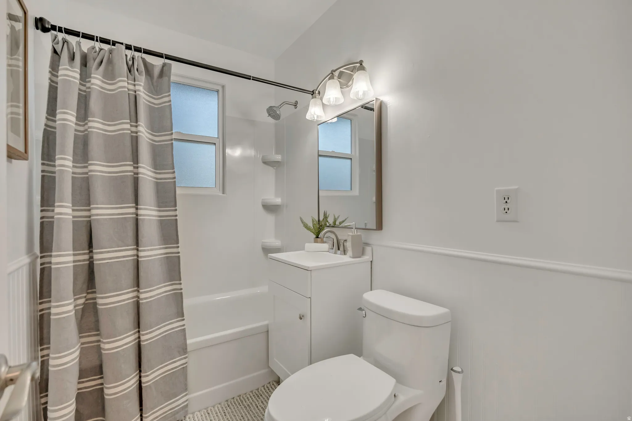 Full bathroom with shower / tub combo and vanity