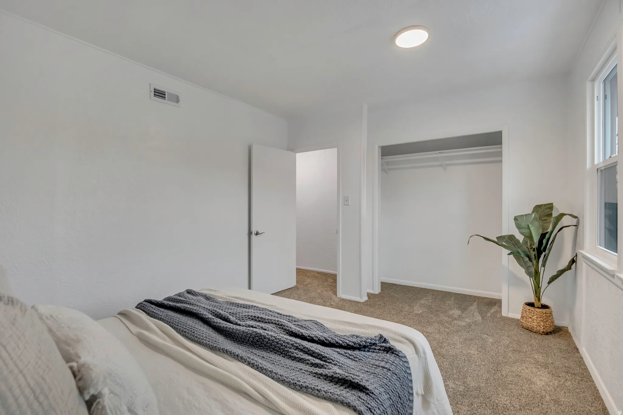 Bedroom with carpet flooring and a closet