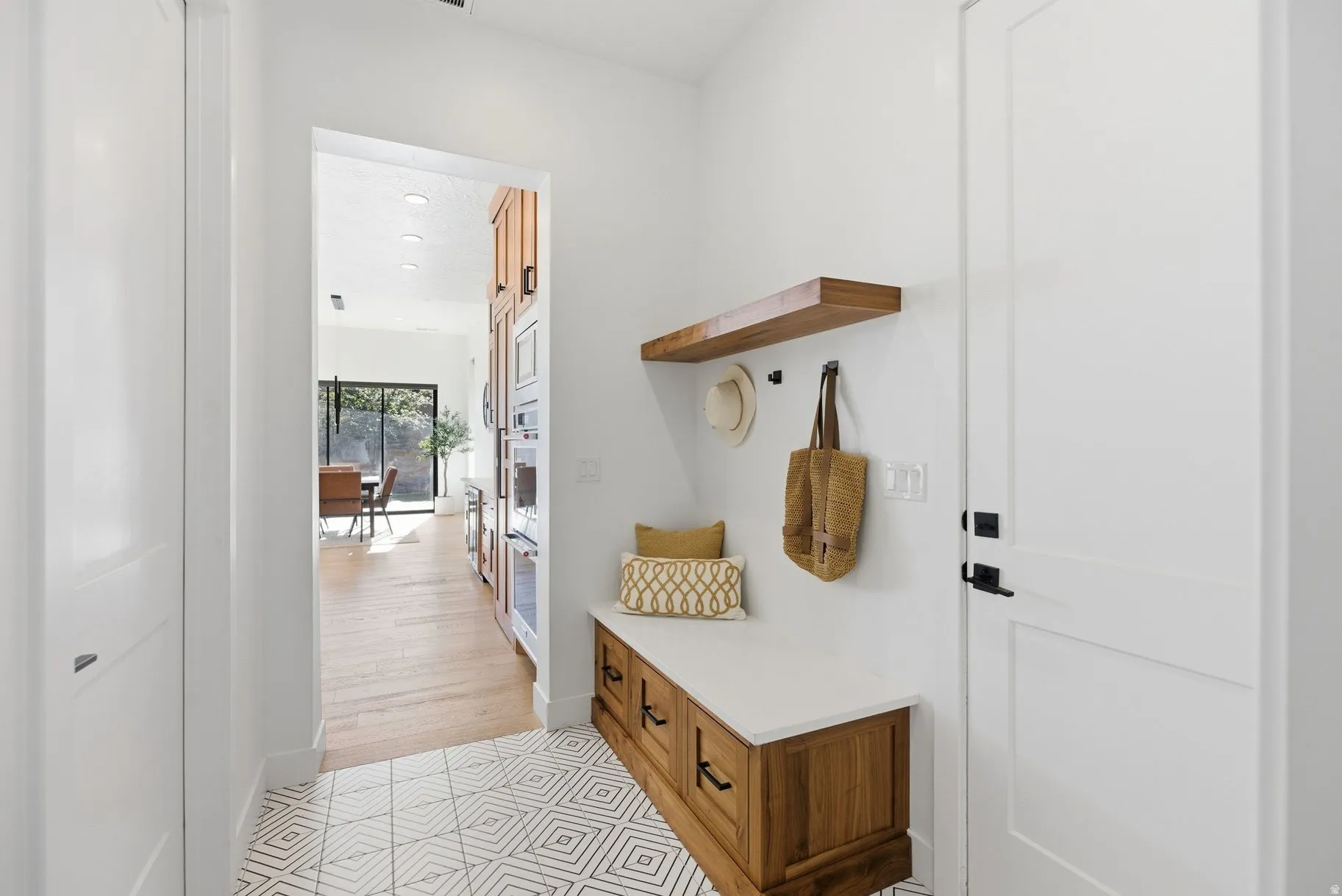 Mudroom with light wood-type flooring and recessed lighting